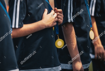 stock-photo-sports-kids-players-with-golden-medals-standing-in-a-row-during-celebration-medals-hanging-around-1627373326